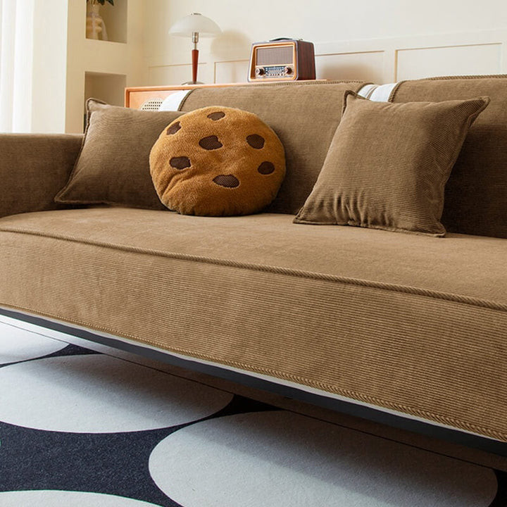 Stylish anti-slip corduroy couch cover in a modern living room, safeguarding furniture from pets.