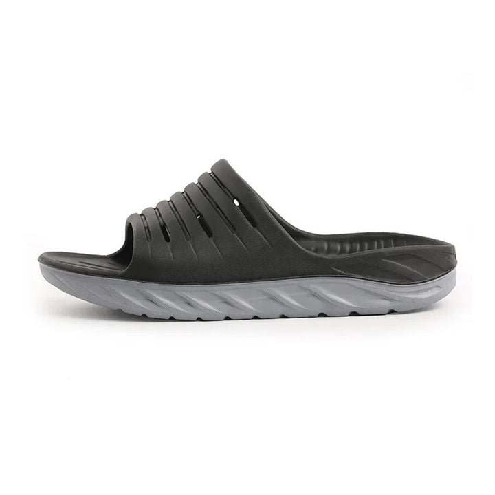 Unisex arch support slides in black, offering heel & arch relief. Ideal comfort footwear for daily pain relief.
