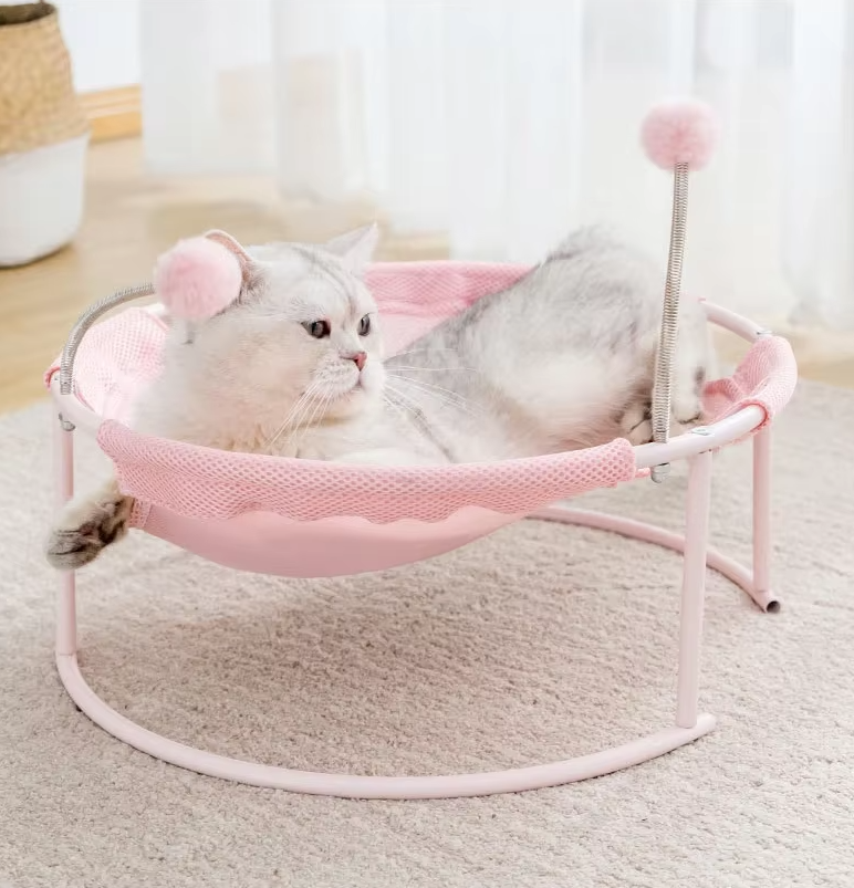 Close-up of blue cat hammock with plush play balls, round design & stable frame