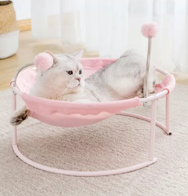 Close-up of blue cat hammock with plush play balls, round design & stable frame