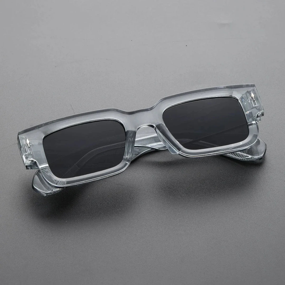 Close-up of the thick frame on bold rectangular sunglasses, a modern unisex eyewear accessory.