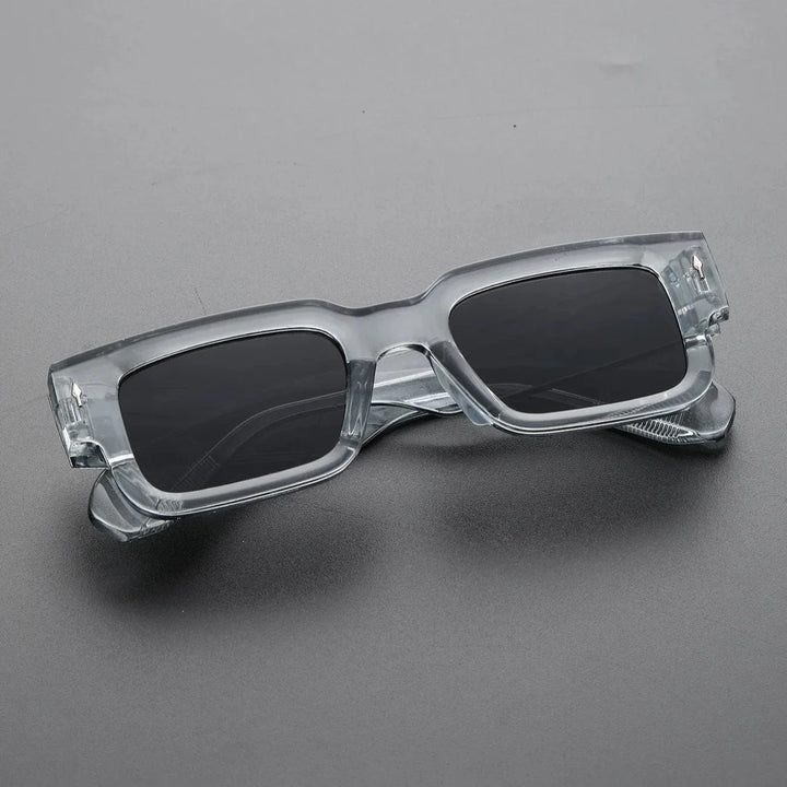 Close-up of the thick frame on bold rectangular sunglasses, a modern unisex eyewear accessory.