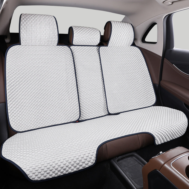 Breathable car seat protector being installed, showing its ease of use and secure fit.