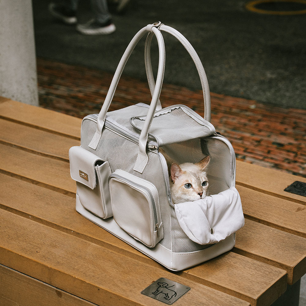 Folded breathable pet carrier next to a ruler, showing compact size for storage