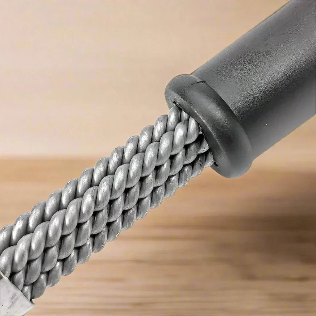 Close-up of a sturdy bristle-free stainless steel grill brush, showing its effective cleaning coils.