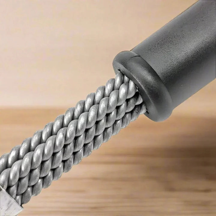 Close-up of a sturdy bristle-free stainless steel grill brush, showing its effective cleaning coils.