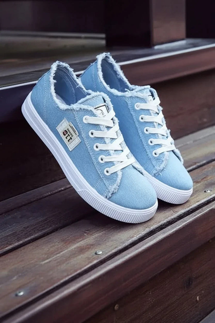 Side profile of comfortable unisex high-top lace-up sneakers, ideal for casual everyday wear.