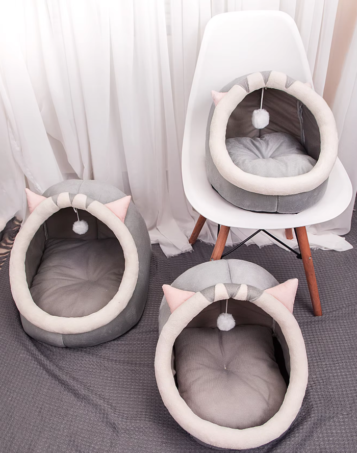 Gray pet house igloo bed for cats, featuring a plush interior and a hanging play ball for entertainment.