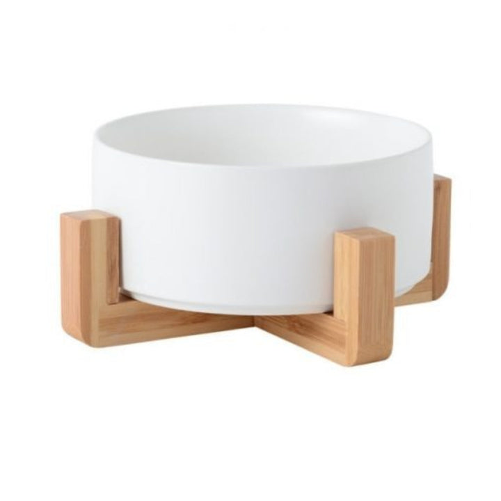 Spill-proof ceramic pet bowl on an elevated wooden stand, ideal for cats and dogs