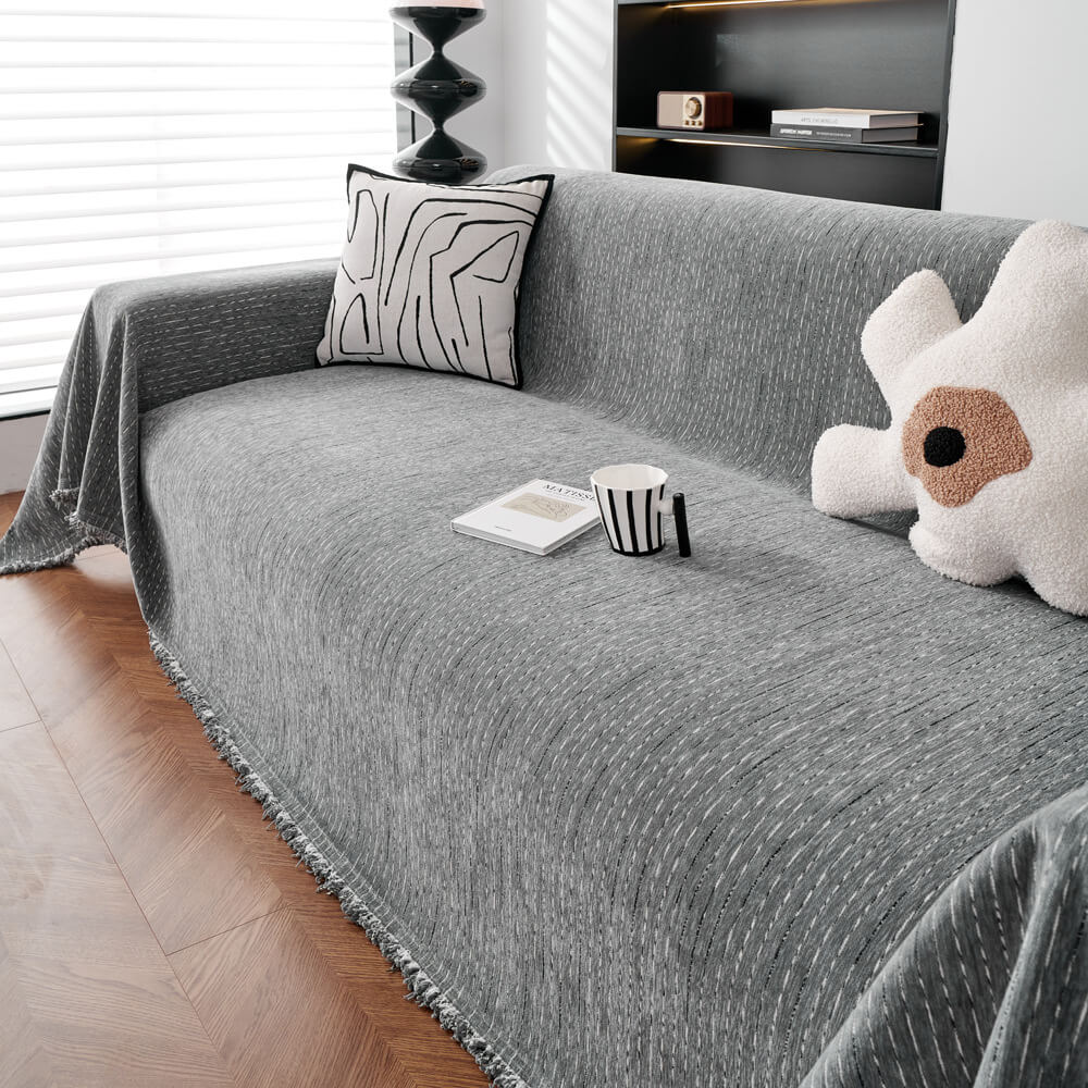 Elegant chenille couch throw protecting a living room sofa, showcasing its all-season durability