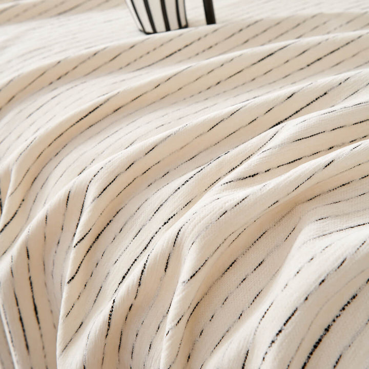 Chenille sofa cover fully covering a three-seater couch, ensuring all-season protection and style