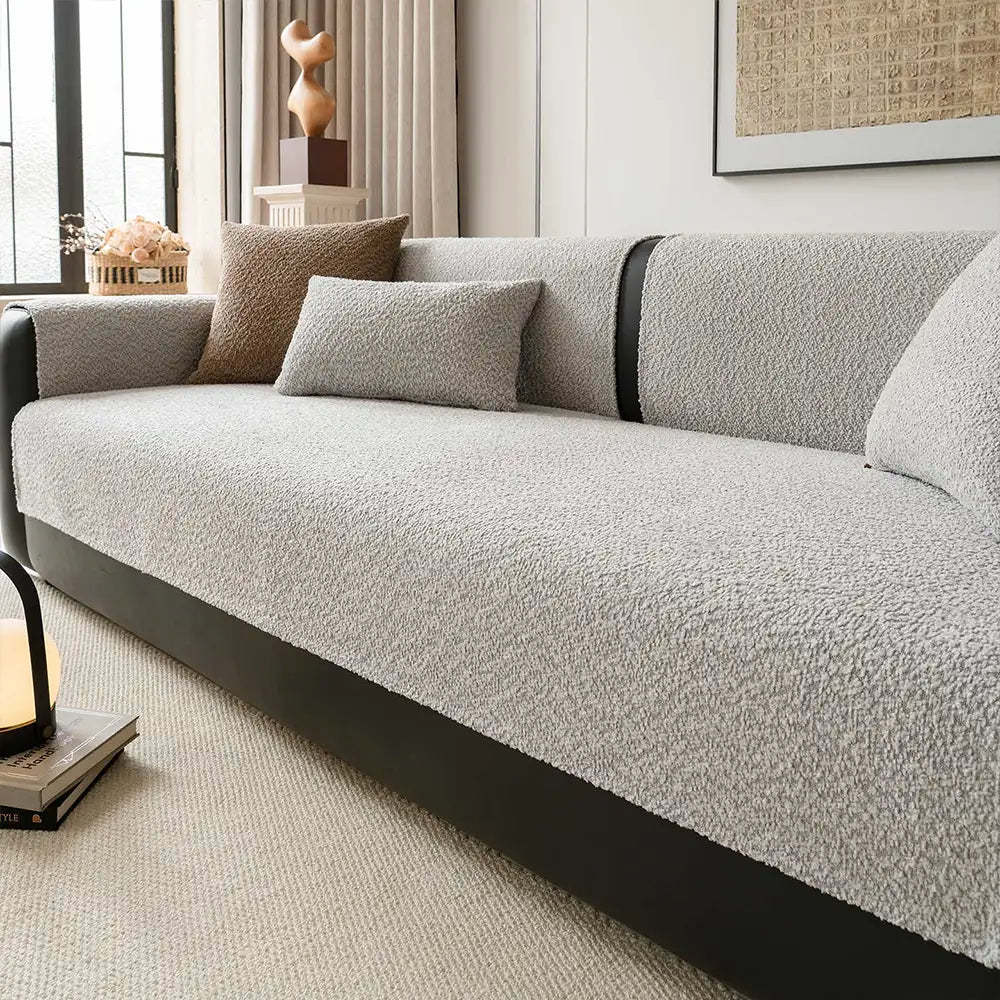 Elegant chenille couch cover draped over a sofa, offering all-season furniture protection and home decor