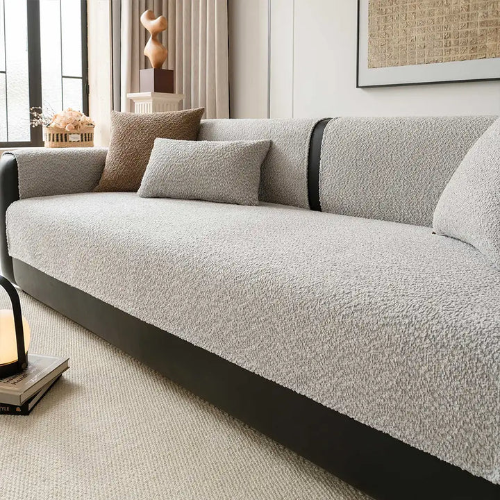 Elegant chenille couch cover draped over a sofa, offering all-season furniture protection and home decor