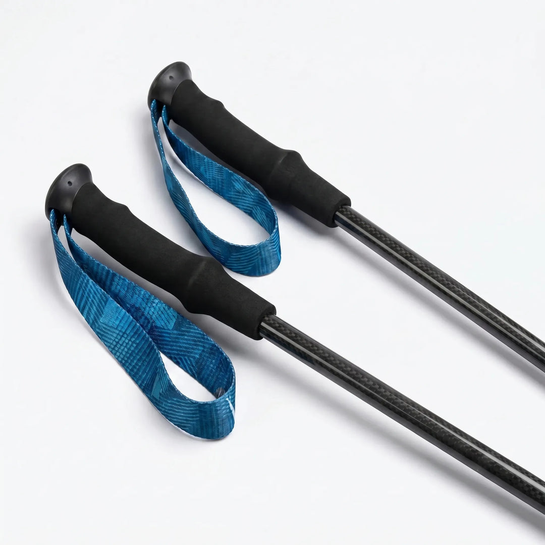 Lightweight carbon fiber trekking poles, collapsible for easy packing. Ideal for hiking & adventure.