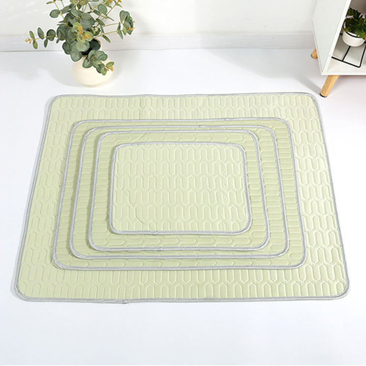 A dog napping peacefully on a blue cooling pet mat, breathable and comfortable
