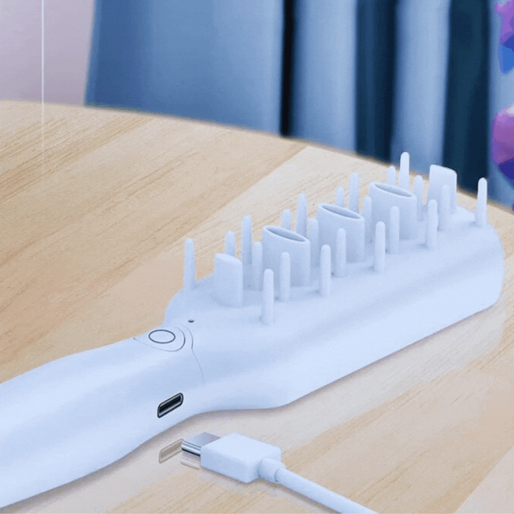 Hand holding a unisex electric pet brush, ideal for pet care and animal grooming massage