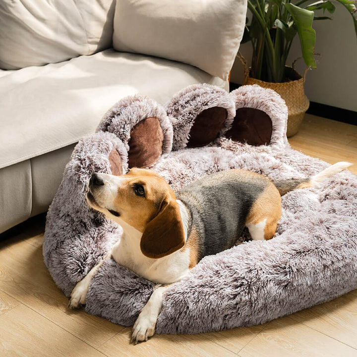 Fluffy cat bed, round and cozy, designed for anxiety relief in small pets.