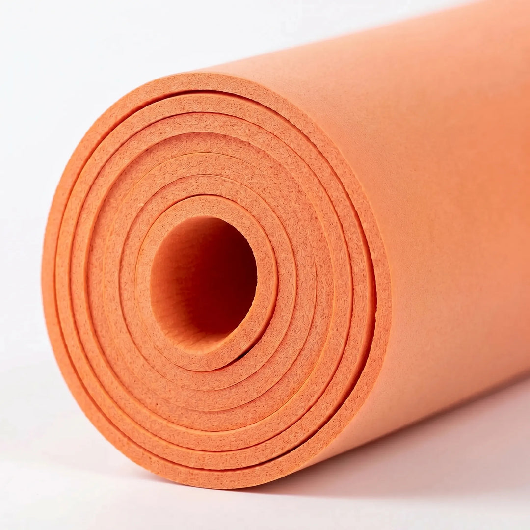 Practicing Pilates on a thick cushioned exercise mat. Non-slip fitness mat for comfortable home gym workouts.