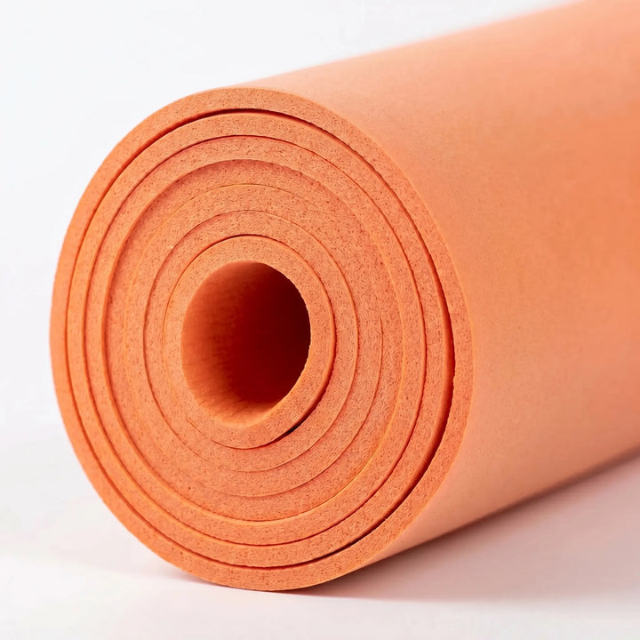 Practicing Pilates on a thick cushioned exercise mat. Non-slip fitness mat for comfortable home gym workouts.