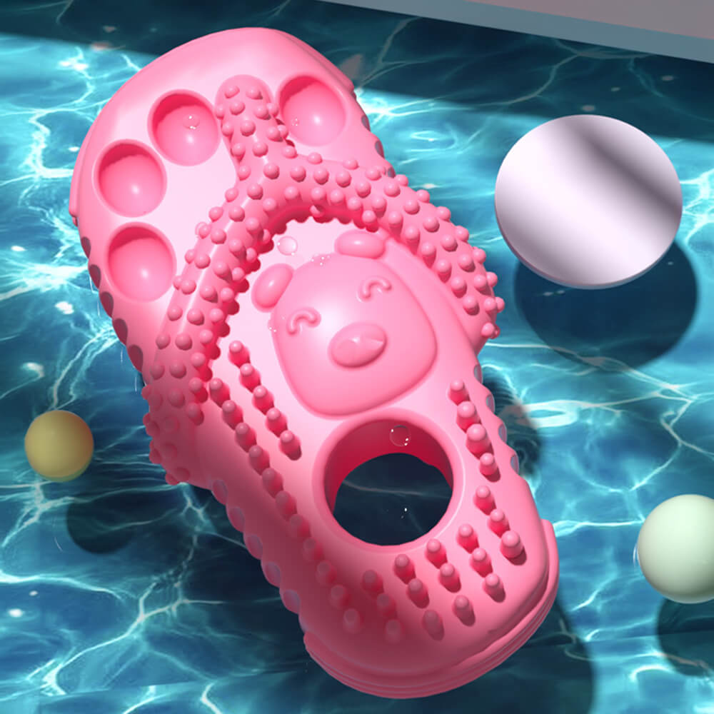 Playful dog gripping the chew slipper toy, demonstrating its durability for active pets