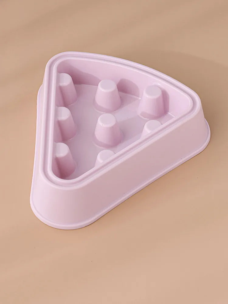 A dog happily eating from a purple interactive slow feeder toy, illustrating pet health benefits
