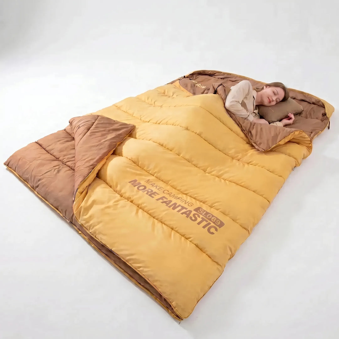 Unisex double sleeping bag spread out for camping; ideal for shared warmth on 4-season hiking trips.