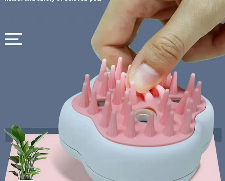 Side view of the rechargeable pet grooming brush, showing power button and spray function
