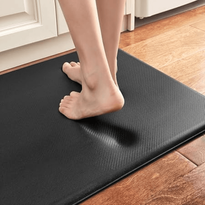 Non-slip ergonomic kitchen mat, offers anti-fatigue standing comfort & secure footing for home cooking.
