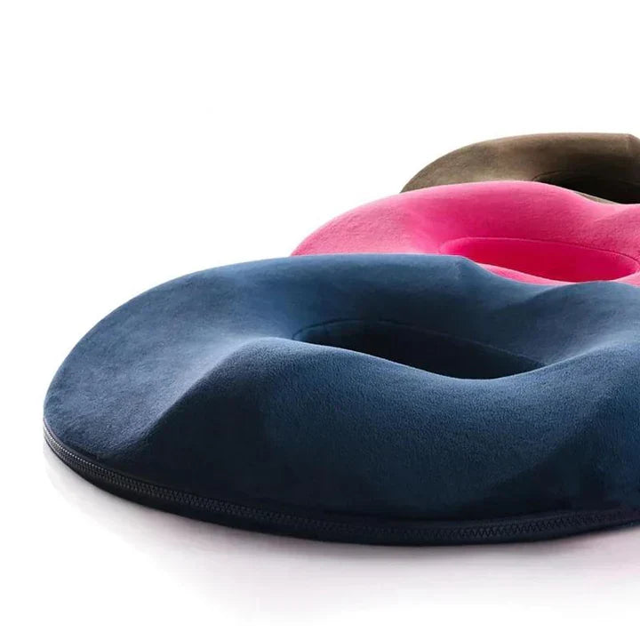 Unisex ergonomic donut seat cushion for tailbone & coccyx relief, perfect for office chairs & car seats.