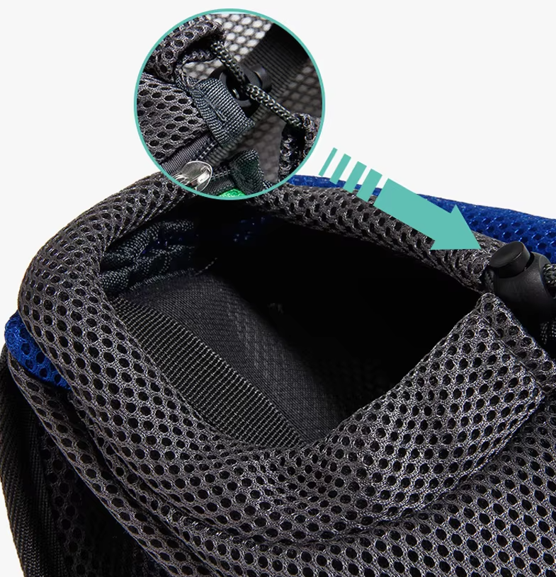 Person wearing a unisex ergonomic pet sling carrier with a small pet inside, walking outdoors