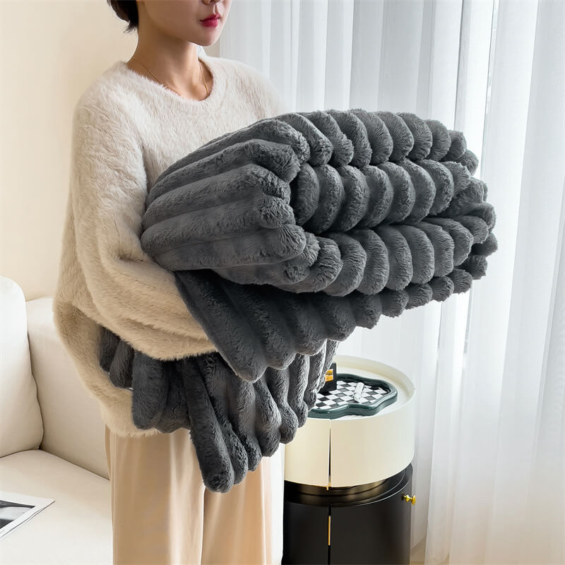 Warm faux fur blanket draped over an armchair, inviting coziness and relaxation.