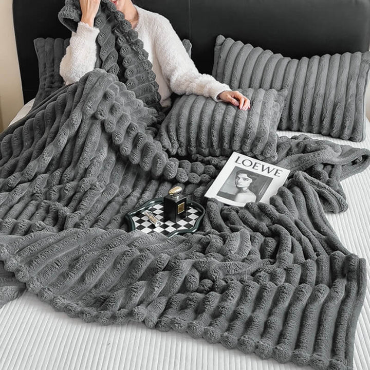 Close-up of a soft, plush faux rabbit fur blanket texture, ideal for sofa and home decor.