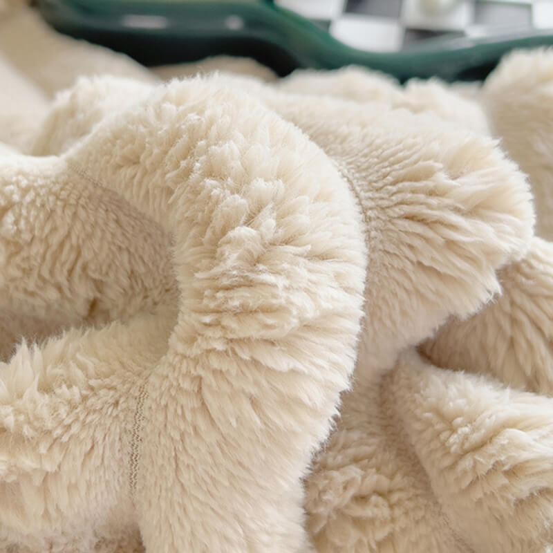 Plush and soft faux fur blanket, perfect for snuggling on a sofa during cold seasons.