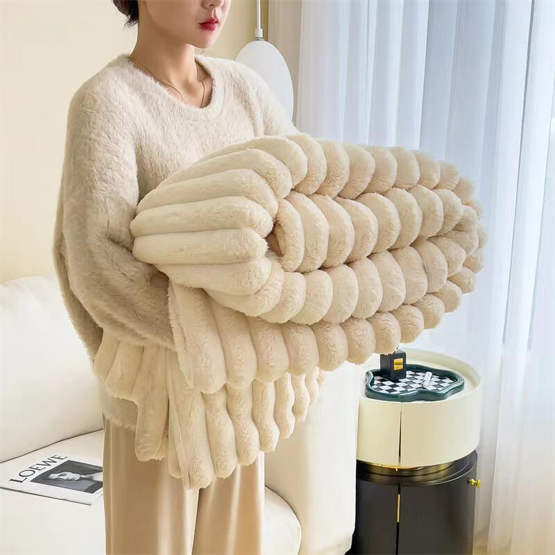 Cozy home decor featuring a faux rabbit fur blanket on a sofa with decorative pillows.
