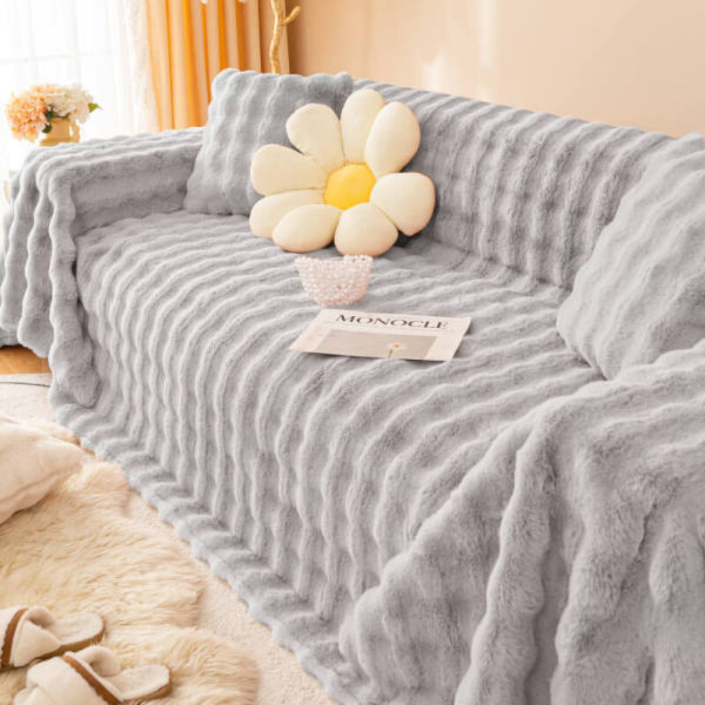 Soft faux rabbit fur couch cover draped over a sofa, showing its full plush texture, home decor
