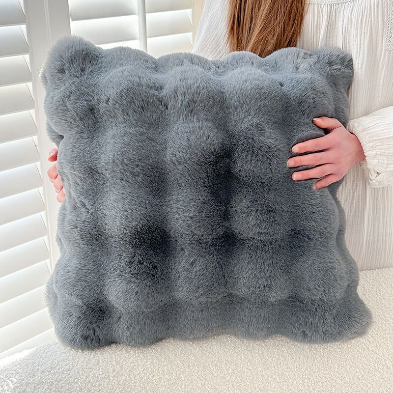 Detail of the non-slip backing on a faux rabbit fur couch cover, ensuring furniture protection