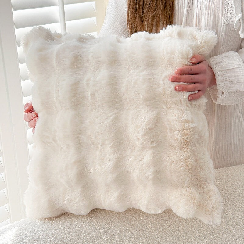 Elegant faux rabbit fur sofa cover on a living room couch, enhancing home decor and comfort