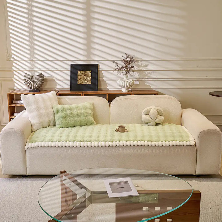 Detail of non-slip backing on a faux fur sofa cover, ensuring furniture protection and stability