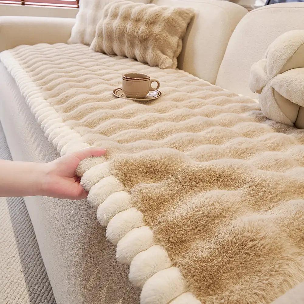 Unisex faux rabbit plush couch cover draped on a sofa, non-slip for pet friendly furniture