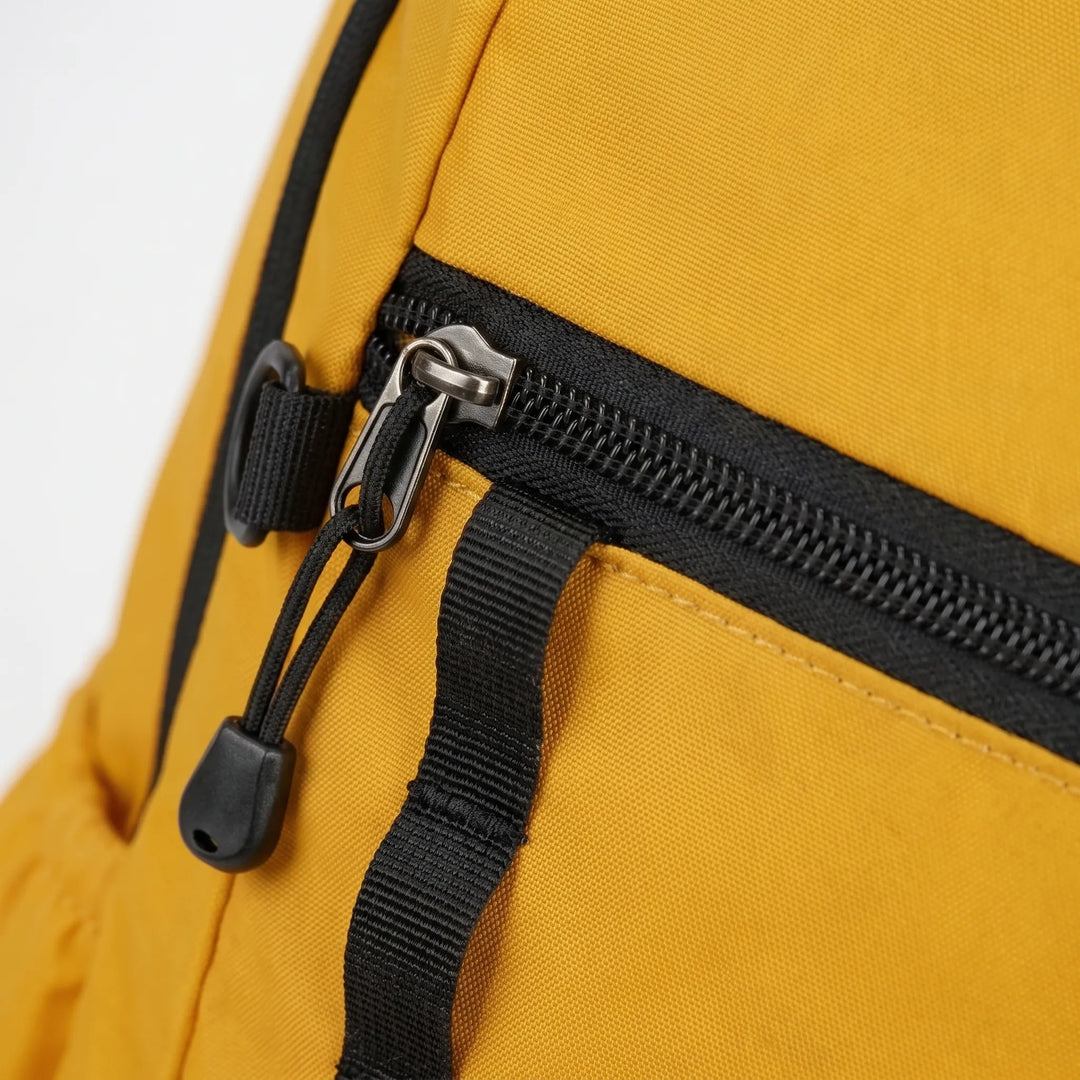 Hiker on a trail wearing a lightweight cyan foldable daypack. Perfect unisex travel pack for adventure & outdoor gear.