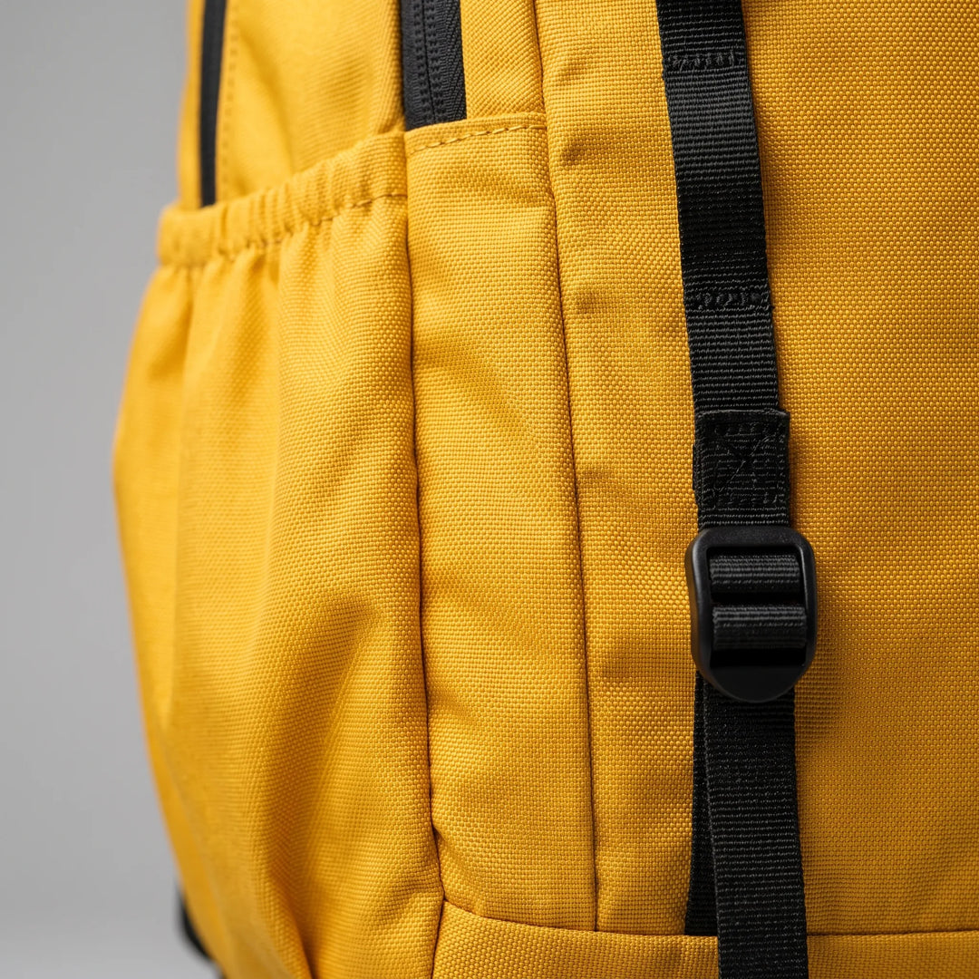 Compact cyan foldable travel daypack neatly packed in a suitcase, ready for adventure & outdoor trips.