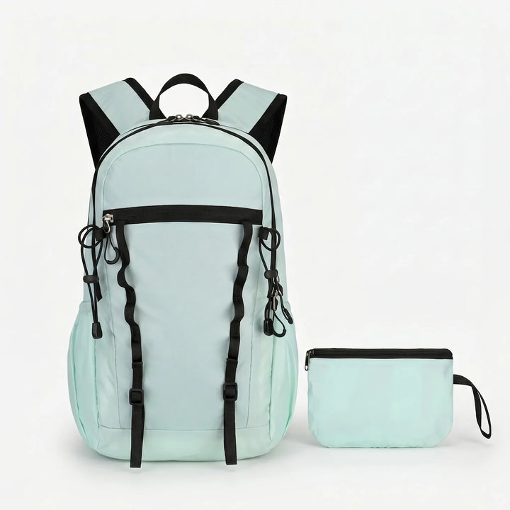 Durable, water-resistant fabric of a cyan foldable hiking daypack. Ideal lightweight outdoor gear for camping.