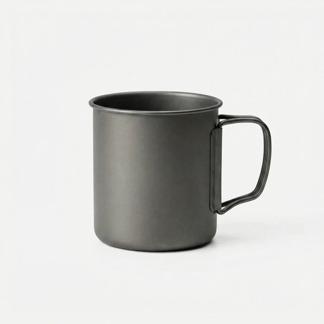 Lightweight titanium mug folded for compact travel, ideal for camping, hiking, and outdoor adventures.