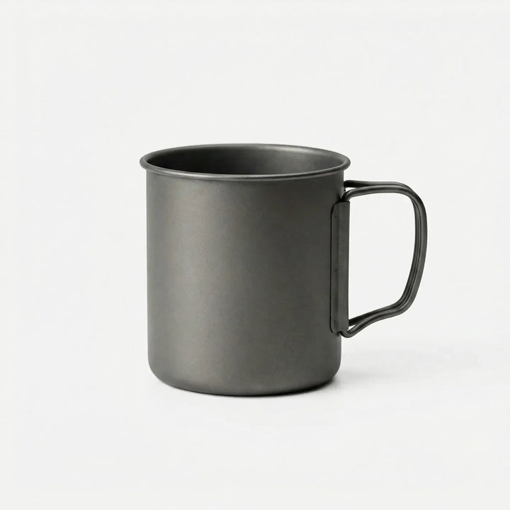 Lightweight titanium mug folded for compact travel, ideal for camping, hiking, and outdoor adventures.