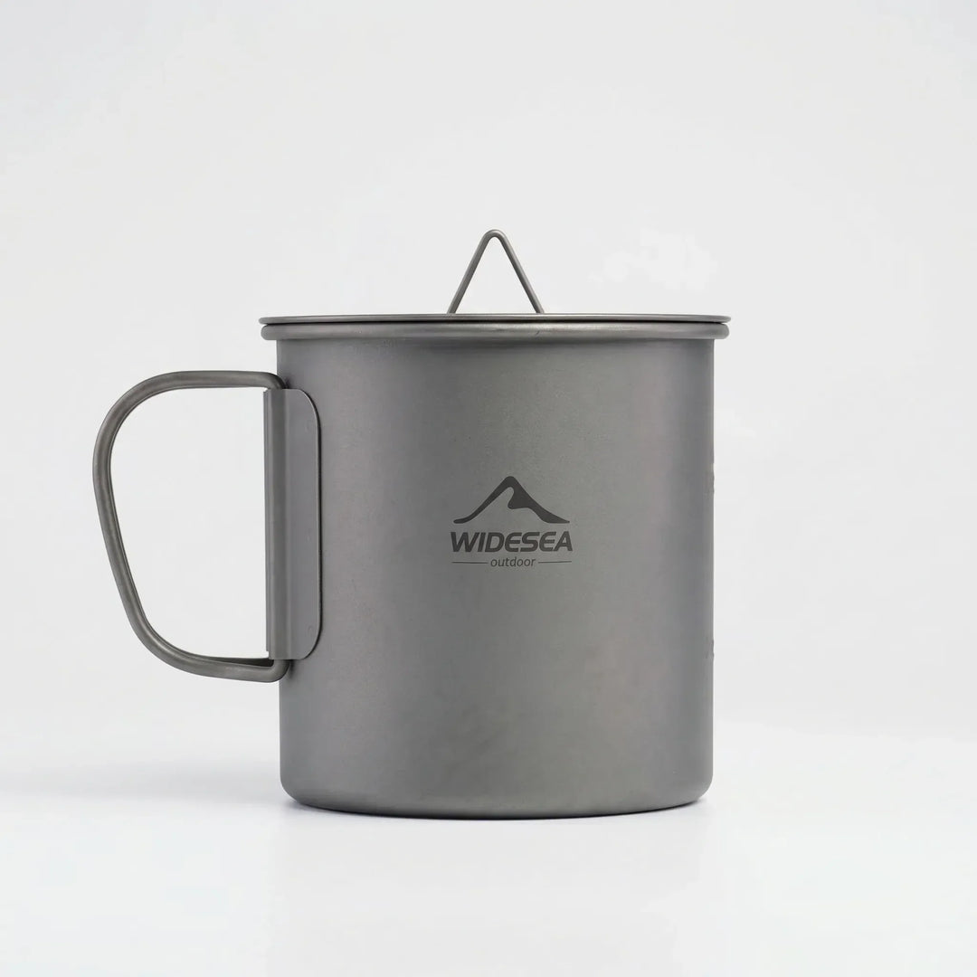Durable and lightweight foldable titanium camping mug, an essential piece of outdoor cookware for any trip.