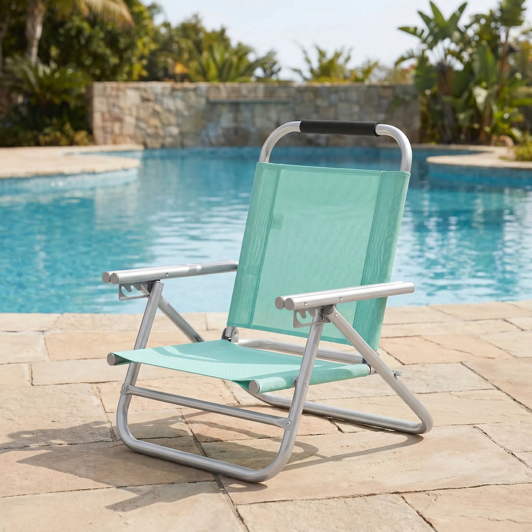 Unisex folding beach chair, adjustable for comfort. Perfect portable outdoor seating for beach or lawn relaxation.