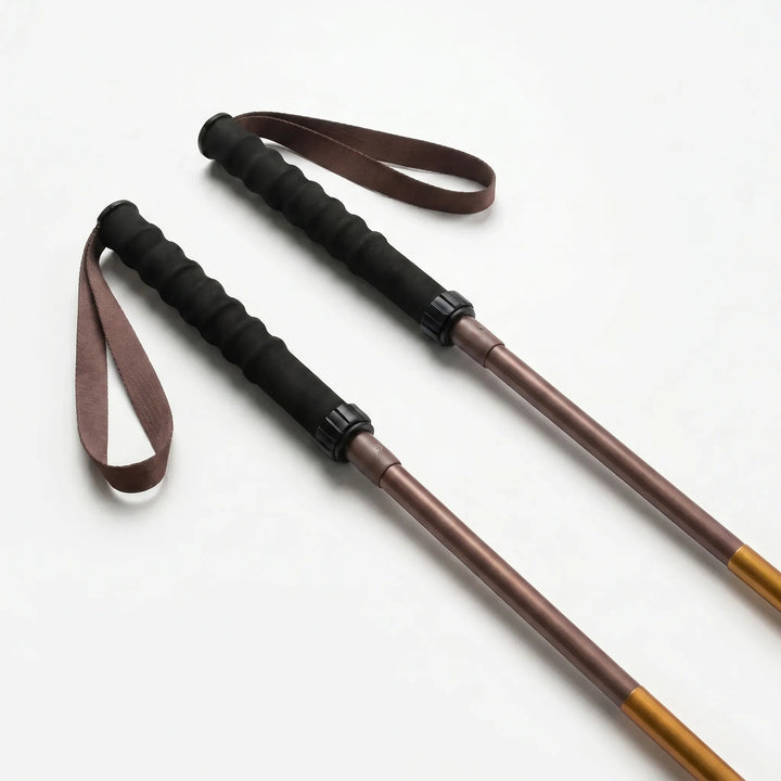Close-up of the quick lock mechanism on a lightweight aluminum folding trekking pole for secure adjustments.