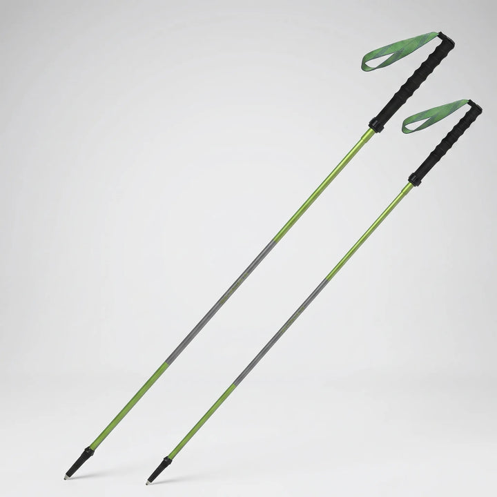 Hiker using a lightweight folding quick lock trekking pole on a rugged outdoor trail, enhancing stability.