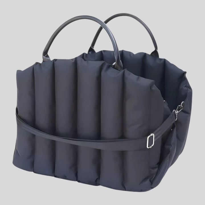 Front view of an empty hands-free dog backpack carrier, highlighting storage pockets and zippers.