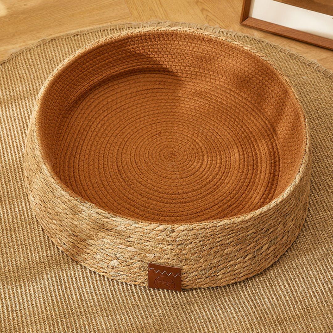 Durable handwoven rattan cat bed with removable cushion, a natural pet furniture solution